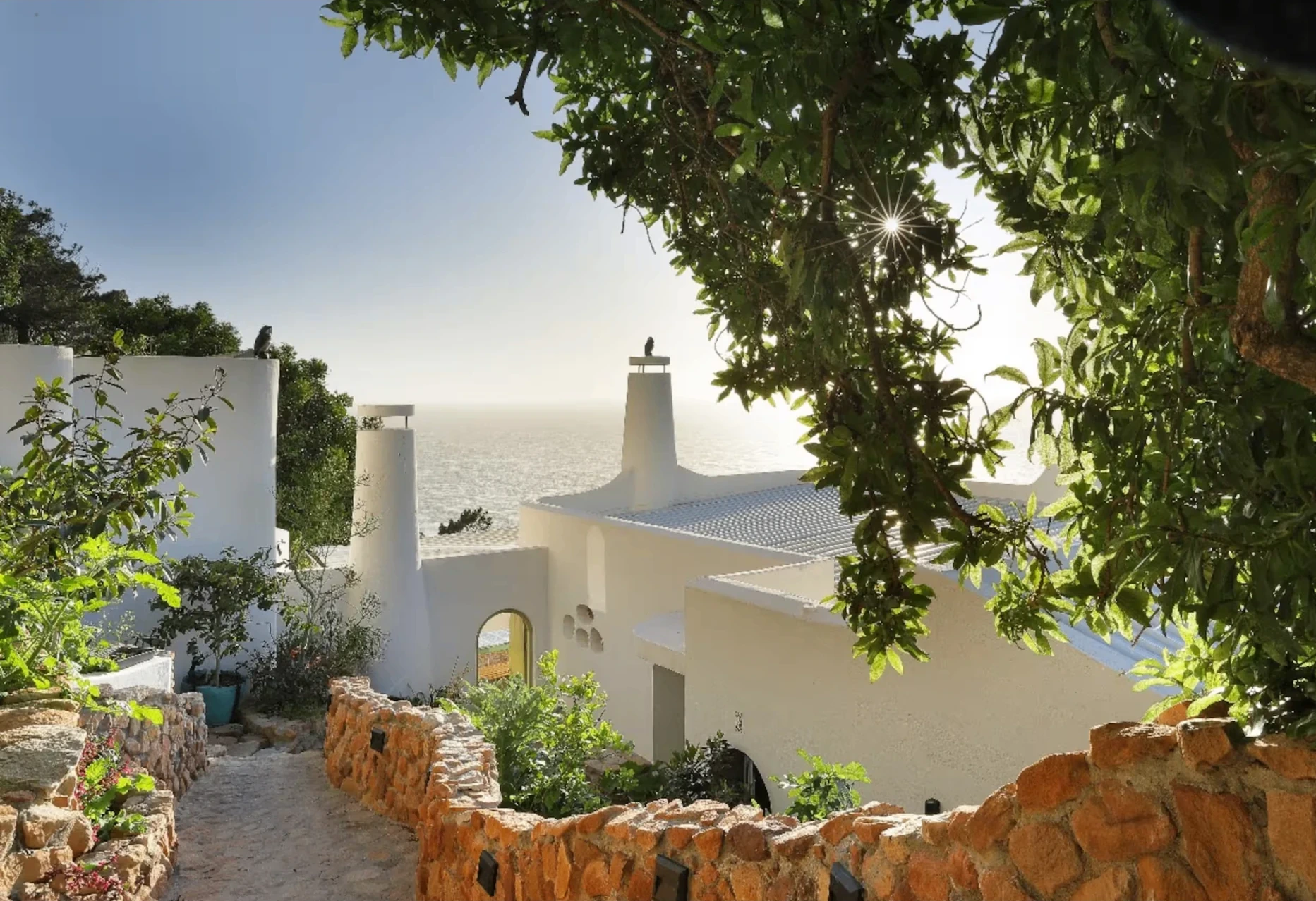 Garden path descending toward Villa Santiago and False Bay in St James